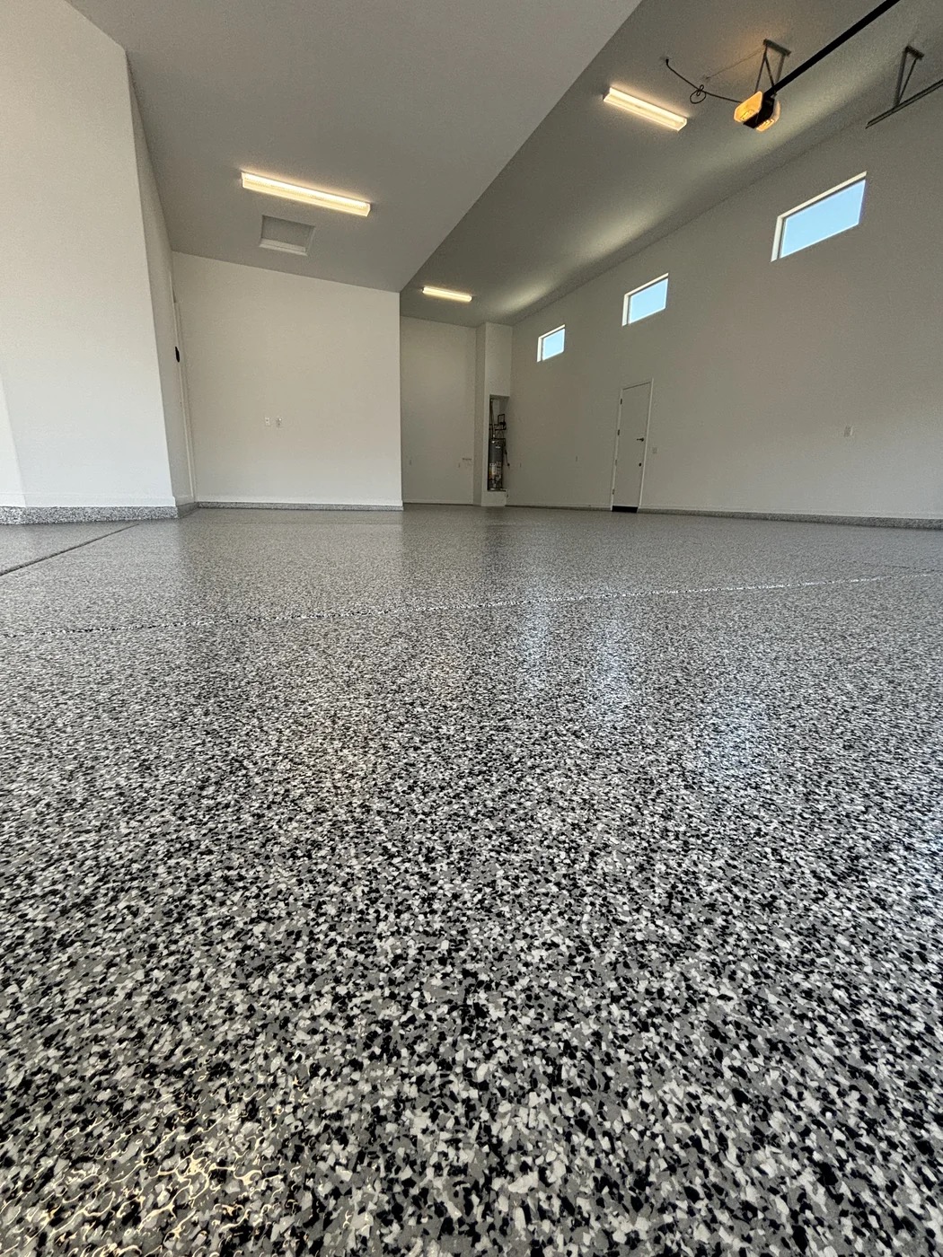 Large garage with gray and black epoxy flake floor